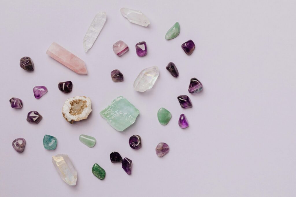 pexels-photo-4040639-4040639 A collection of various crystals and gemstones arranged on a minimalist light surface.